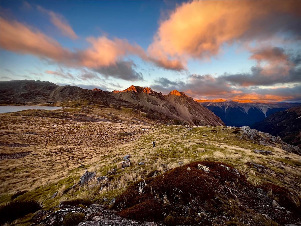 A golden sunset lighting up a mountain ridge, from one of Will and Issy's hikes