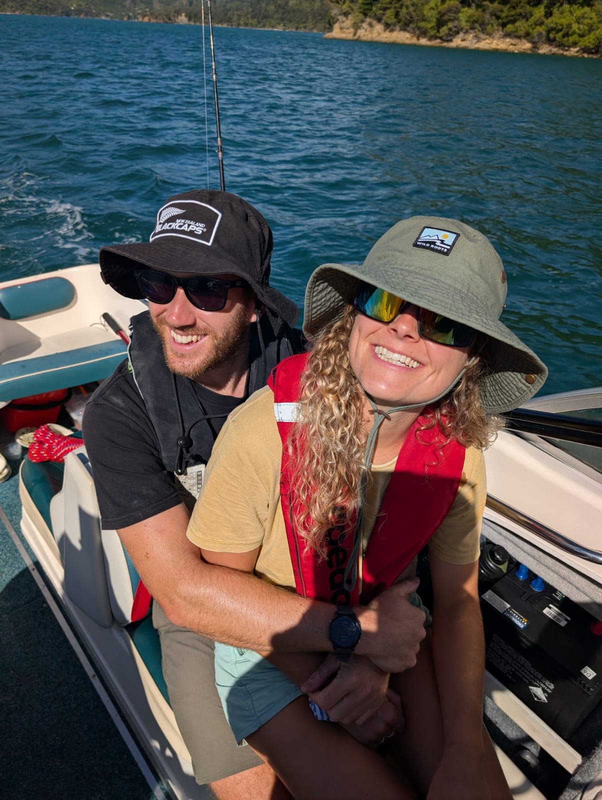 Will and Issy out on the water in New Zealand, life jackets and sunhats on