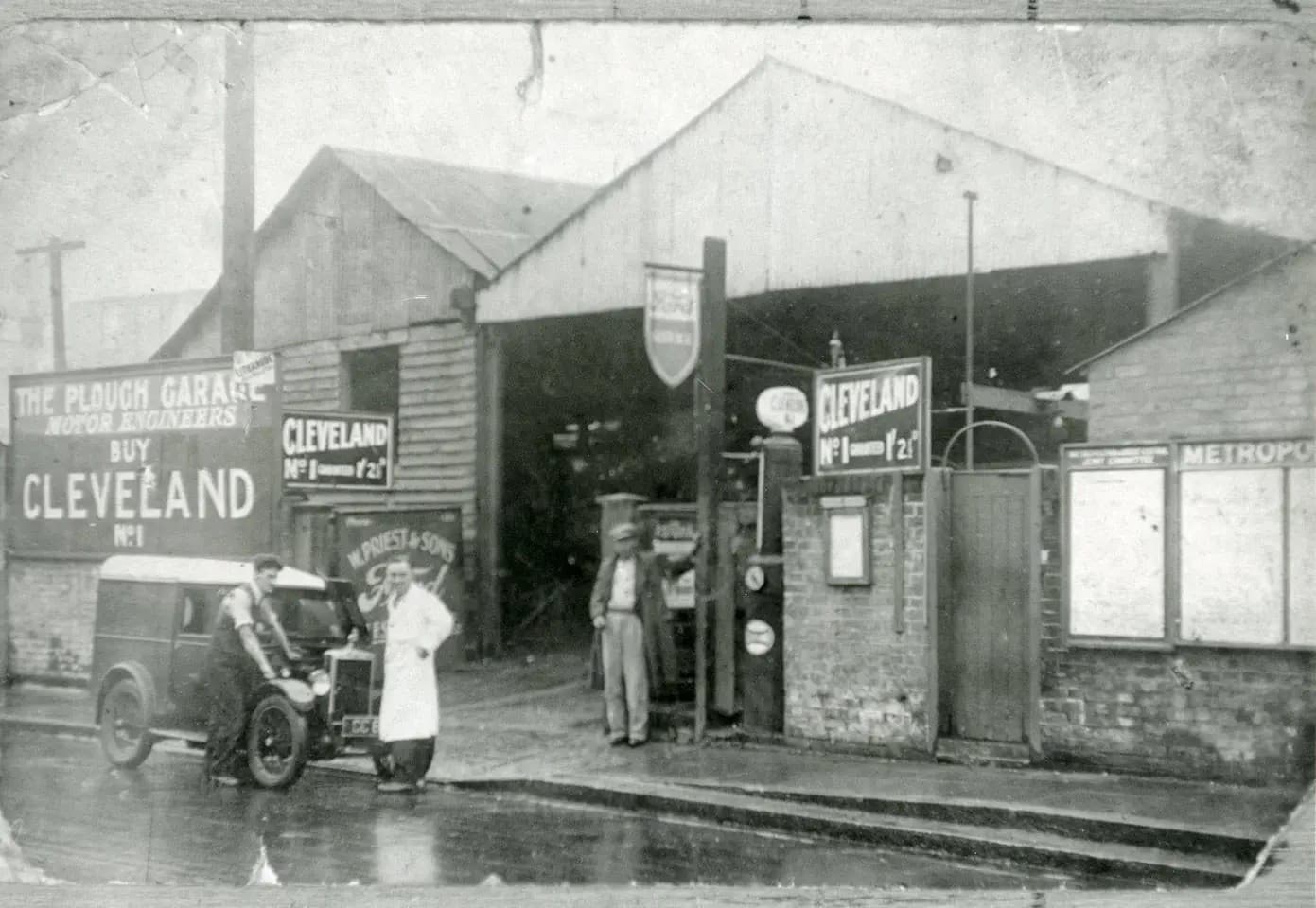 An original archival photo of The Plough Garage and W. Priest & Sons Ford, the Priest family's dealership, with a vintage van out front